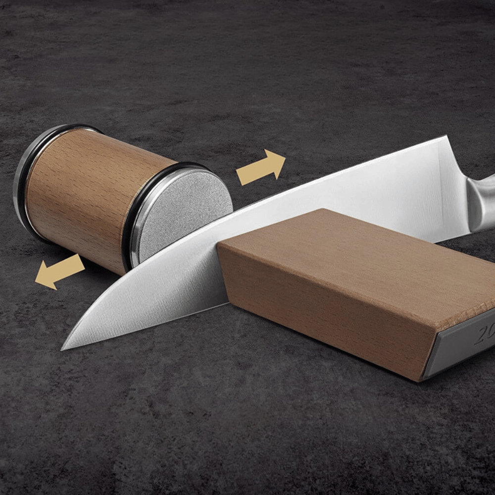 Knife being sharpened with wooden magnetic roller and angled base for controlled motion.