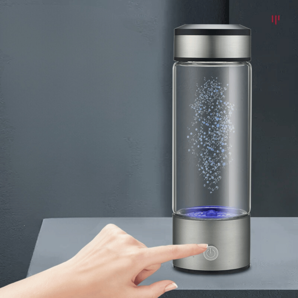 User pressing touch button on hydrogen water generator to activate ionization process for enhanced water quality