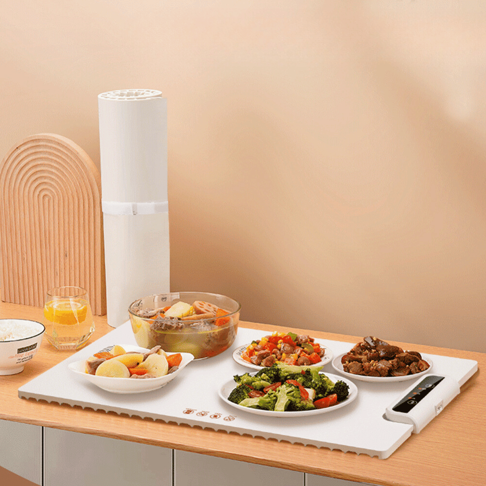 Foldable Food Warmer in use with various dishes and a drink cup on a kitchen counter