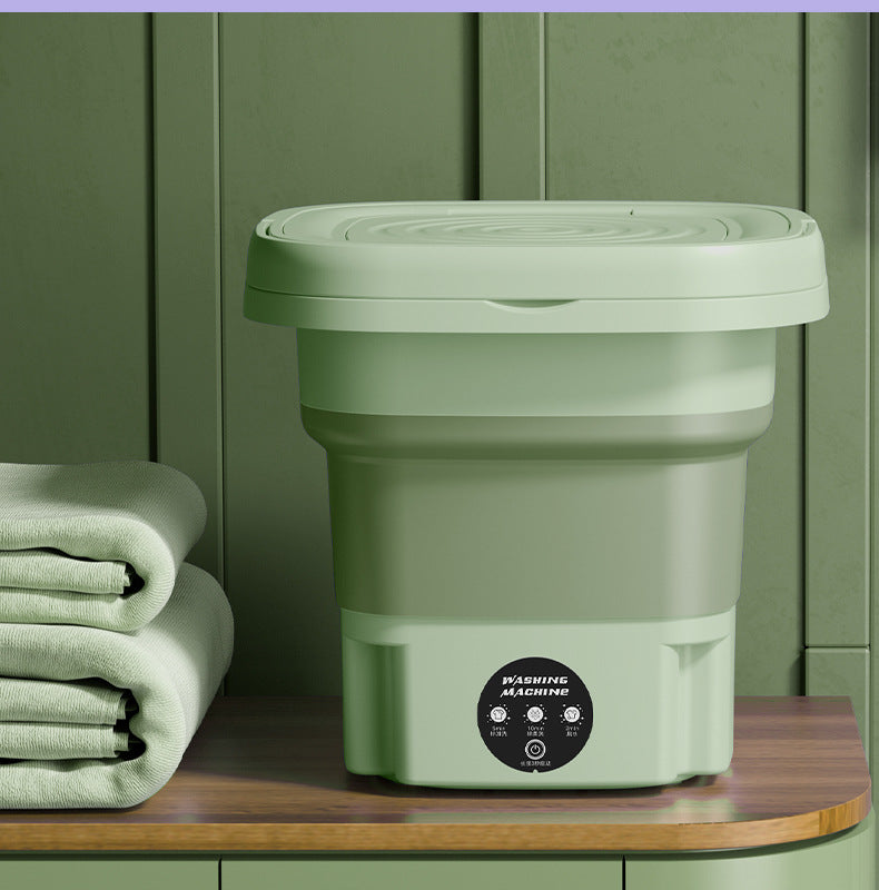 Green foldable washing machine displayed with laundry towels, showing alternate color option