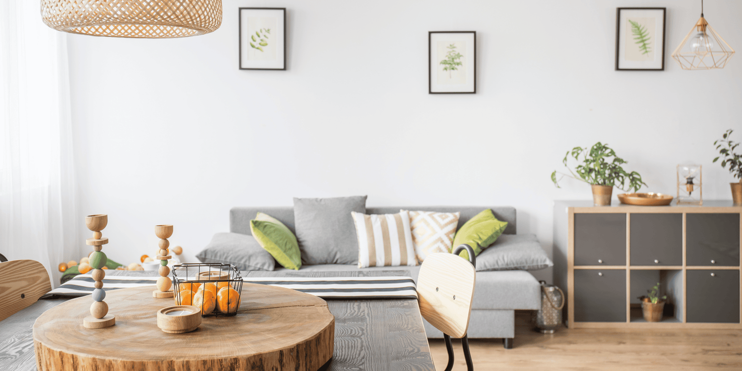 Modern living room with a gray sofa, wooden coffee table, and decorative items.