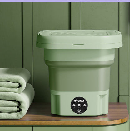 Green foldable washing machine displayed with laundry towels, showing alternate color option